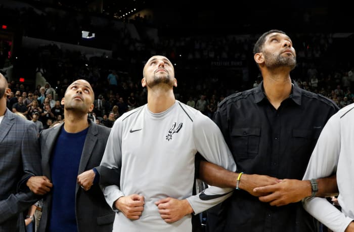Tim Duncan and Tony Parker locking arms with Manu Ginobli.