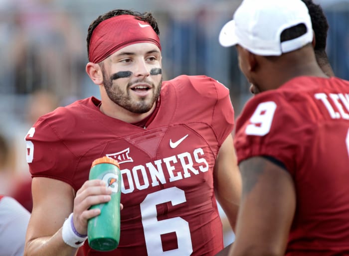 Baker Mayfield holding a Gatorade bottle on the sideline.