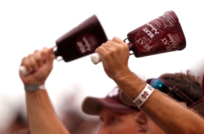 A closeup of Mississippi State fans ringing cow bells.