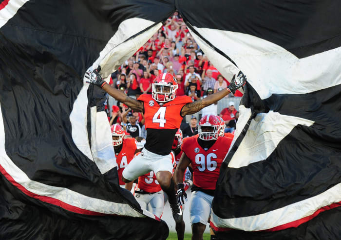 Georgia football players running onto the field.