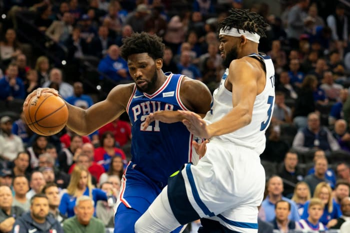 Joel Embiid tries to drive on Karl-Anthony Towns in an NBA game.