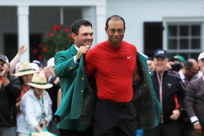tiger woods dons the green jacket at the masters