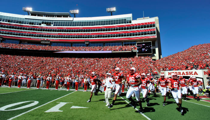 Nebraska Cornhuskers Head Coach Bo Pelini (center) leads his team onto the field before their game against the Udaho Vandals at Memorial Stadium.