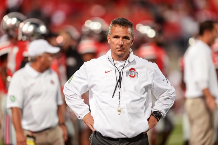 A closeup of Urban Meyer with his hands on his waste.