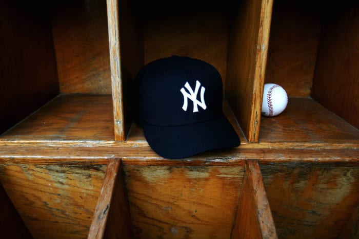 A photo of a New York Yankees hat in an MLB dugout.