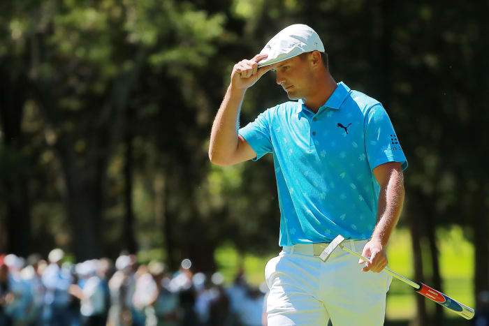 Bryson DeChambeau tips his cap after sinking a putt.