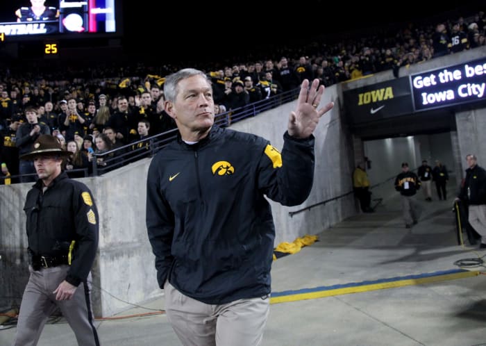 Kirk Ferentz waves to fans as he takes the field at Kinnick Stadium.