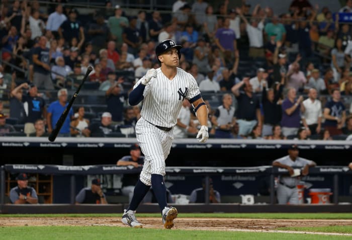 New York Yankees OF Giancarlo Stanton flipping his bat after hitting a home run.
