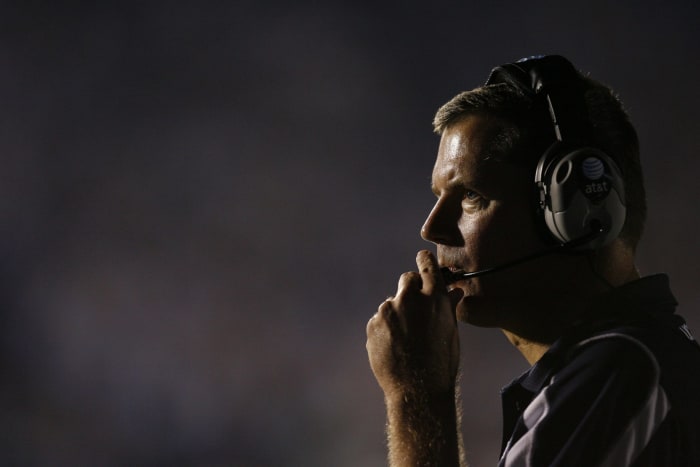 Randy Edsall speaks into headset.