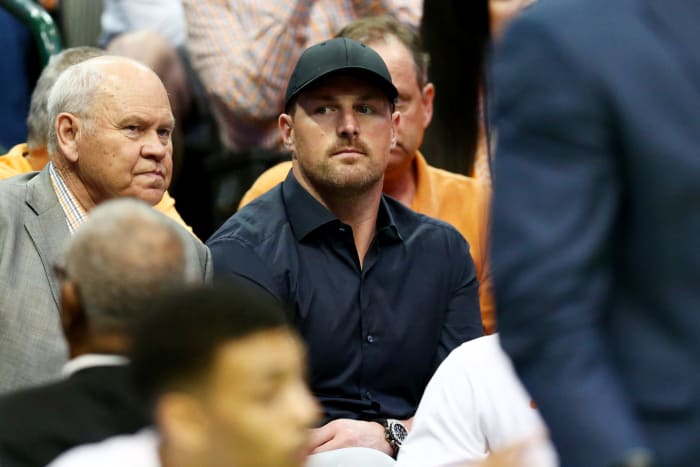 jason witten looks onto the court before a basketball game
