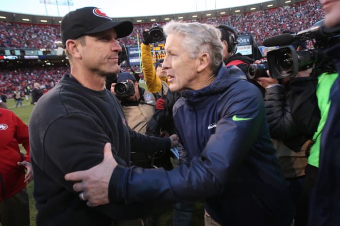 Jim Harbaugh and Pete Carroll shake hands.