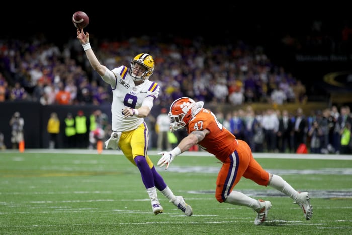 Joe Burrow takes a hit while throwing a touchdown.