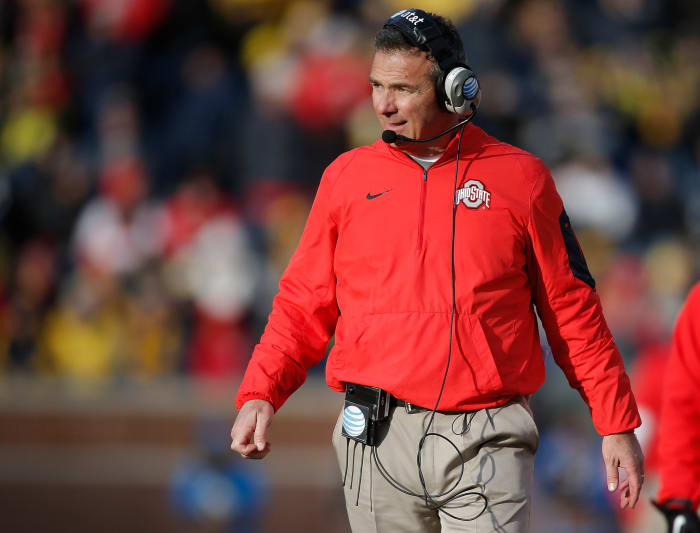 A closeup of Urban Meyer walking down Ohio State's sideline.