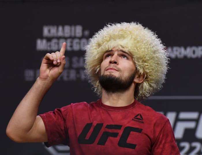 Khabib Nurmagomedov pointing up to the sky.