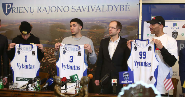 LaVar, LiAngelo and LaMelo Ball holding up with Vytautas uniforms.