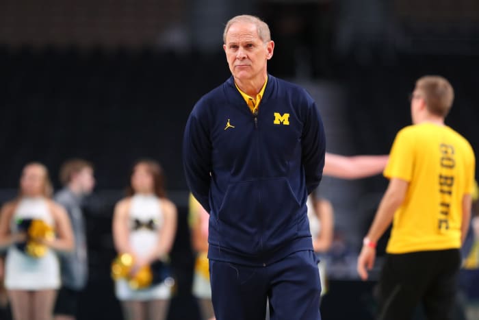 Michigan basketball head coach John Beilein holding his hands behind his back before an NCAA Tournament game.