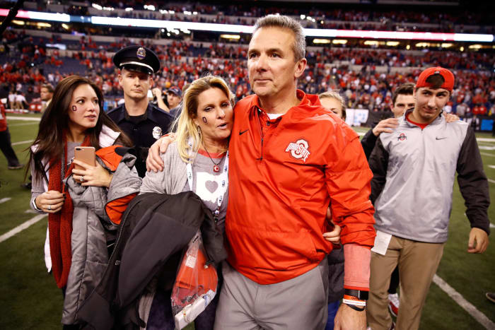 Urban Meyer and his wife exit the field.