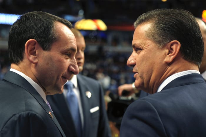 Coach K and Coach Cal chatting at a game.