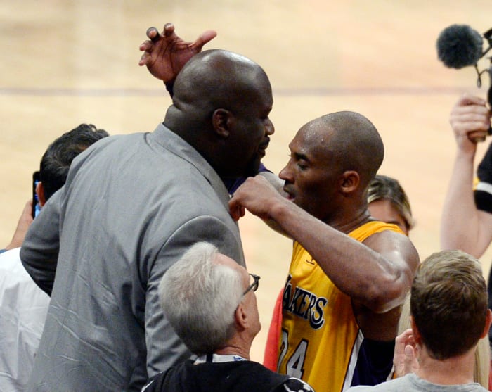 Shaquille O'Neal and Kobe Bryant embrace after the star guard's 60 point performance in his final game.