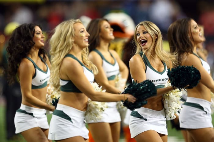 Oregon cheerleaders performing on the sideline.