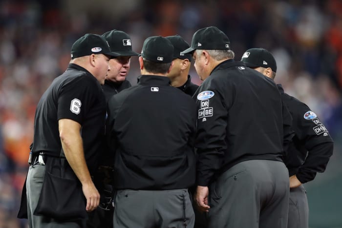 MLB Umpires discussing something.