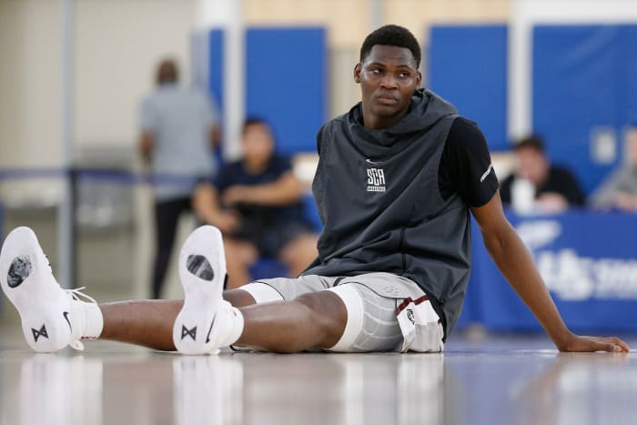 N'Faly Dante stretches before a high school game.