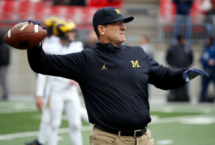 Jim Harbaugh throwing a pass during warmups.