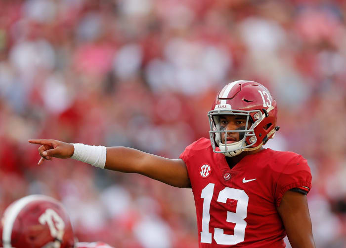 Tua Tagovailoa points directions to a teammate.