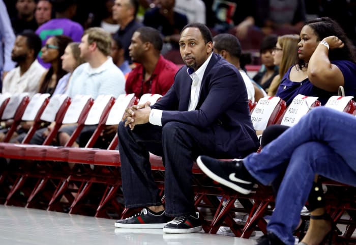 Stephen A Smith sitting court side.