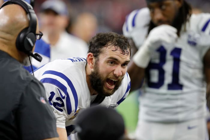 Andrew Luck talking to his teammates on the sideline.