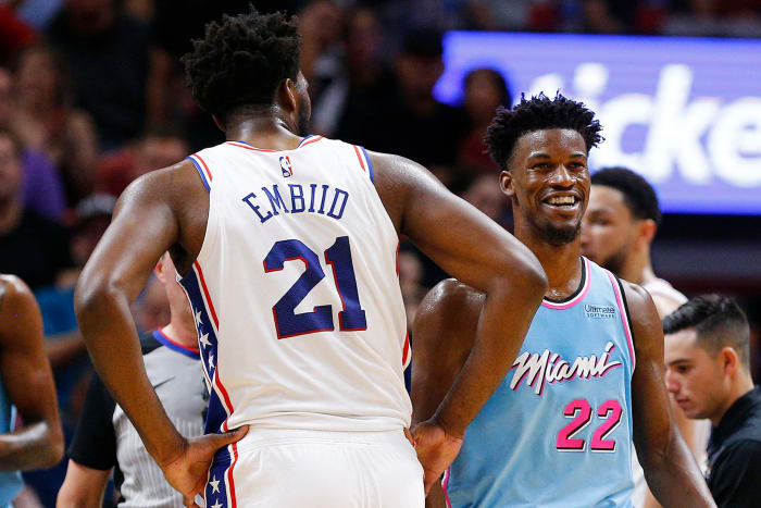 Jimmy Butler and Joel Embiid interact during a game.