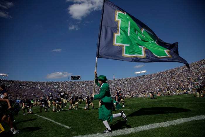 Notre Dame's mascot running with a flag.