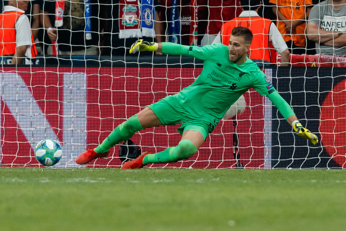 Liverpool goalkeeper Adrian goes for the kick save.