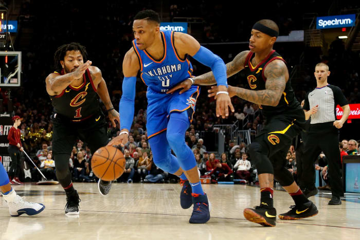 Russell Westbrook dribbling past Derrick Rose and Isaiah Thomas.