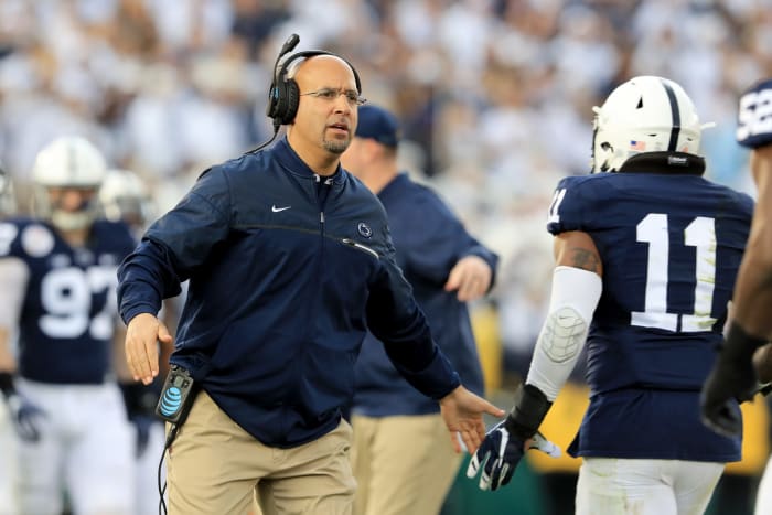 James Franklin high fives his players as they come off the field.