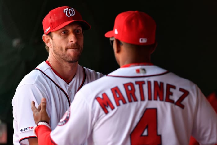 Max Scherzer talking with Dave Martinez in the dugout.