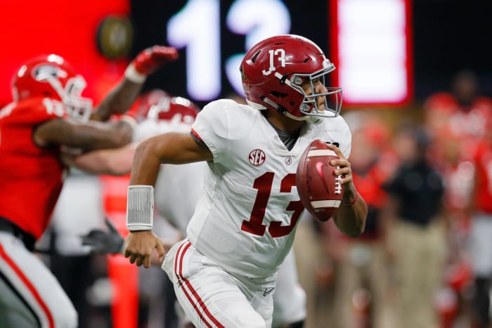 Tua Tagovailoa #13 of the Alabama Crimson Tide rolls out on a pass play during the third quarter against the Georgia Bulldogs.