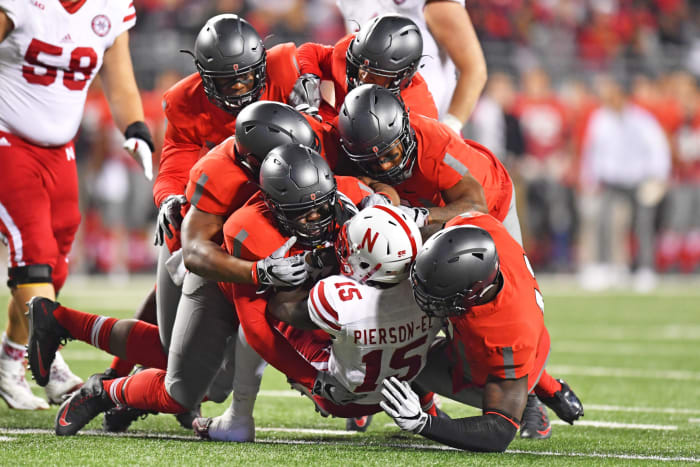 Ohio State players tackling a Nebraska football player.