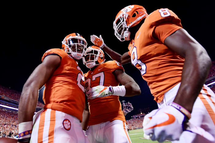 Clemson Quarterback Kelly Bryant #2, wide receiver Deon Cain #8, and tight end D.J. Greenlee #87 of the Clemson Tigers celebrate following Bryant's touchdown.