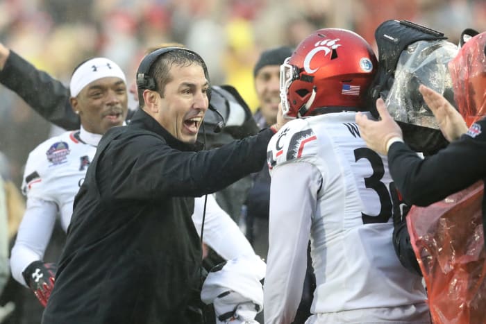 Luke Fickell motivates a Cincinnati player.