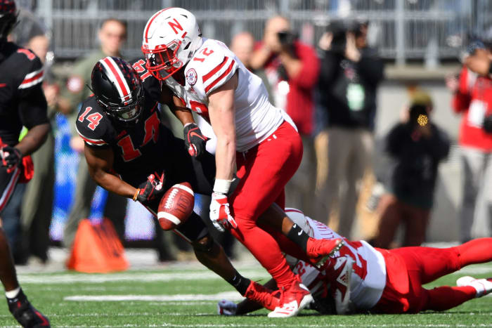 Nebraska football linebacker Luke Gifford making a tackle on Ohio State's K.J. Hill during a Big Ten football game.