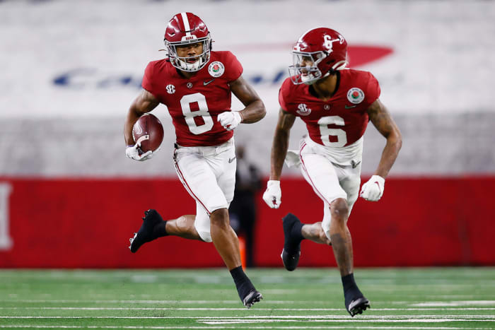 John Metchie runs after the catch during a College Football Playoff game.