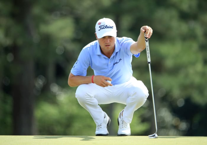 Justin Thomas lining up for a putt.