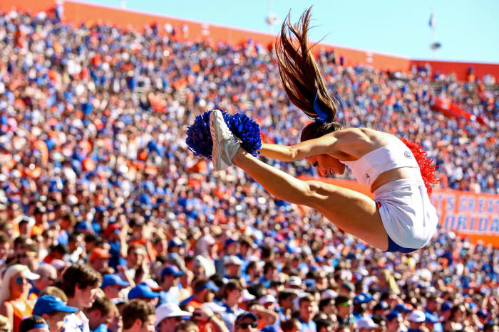 A Florida Gators cheerleader performing during a football game.