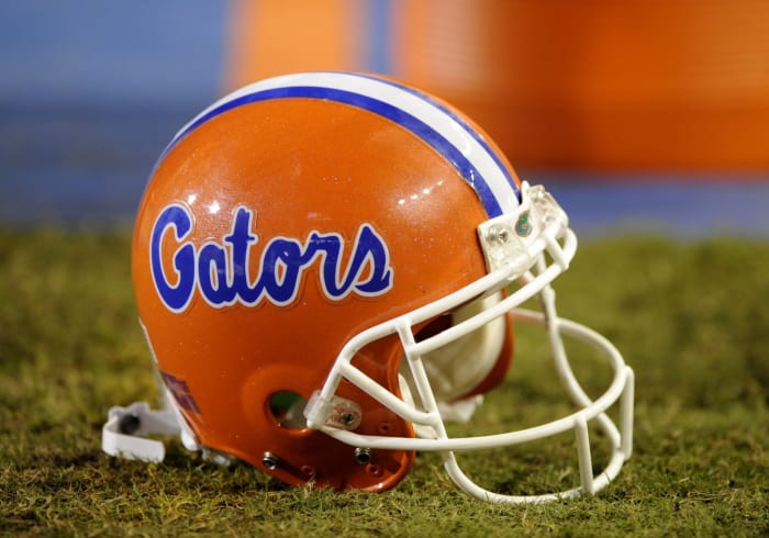 A Florida Gators football helmet sitting on the field.