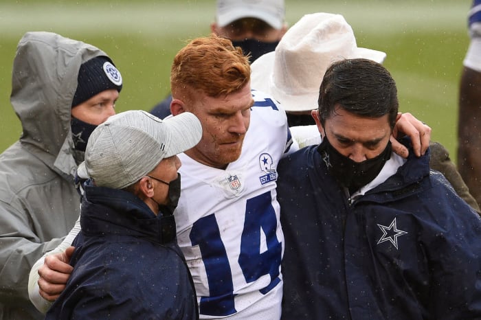Dallas Cowboys quarterback Andy Dalton gets helped off the field.