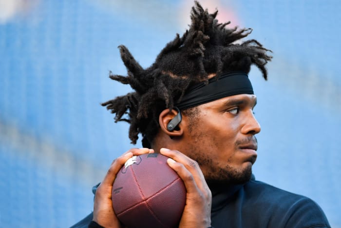 Cam Newton warms up before a game against the Patriots.