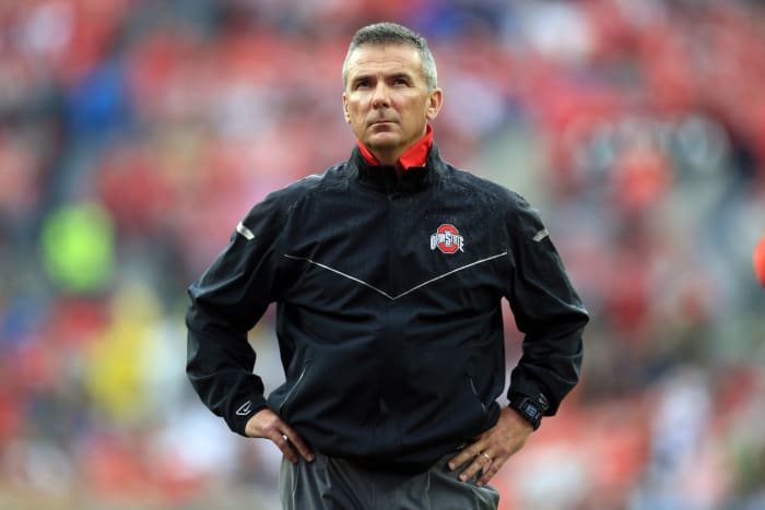 A closeup of Urban Meyer wearing a black Ohio State jacket.