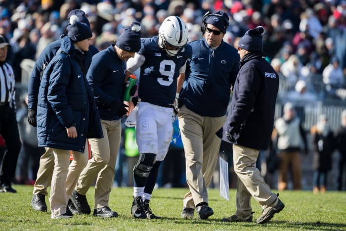 James Franklin assists Trace McSorley off the field.