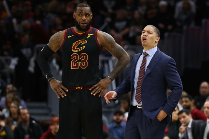 Tyronn Lue standing behind LeBron James